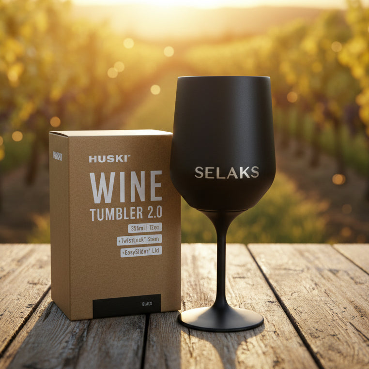 Black wine tumbler with 'SELAKS' branding next to a Huski Wine Tumbler